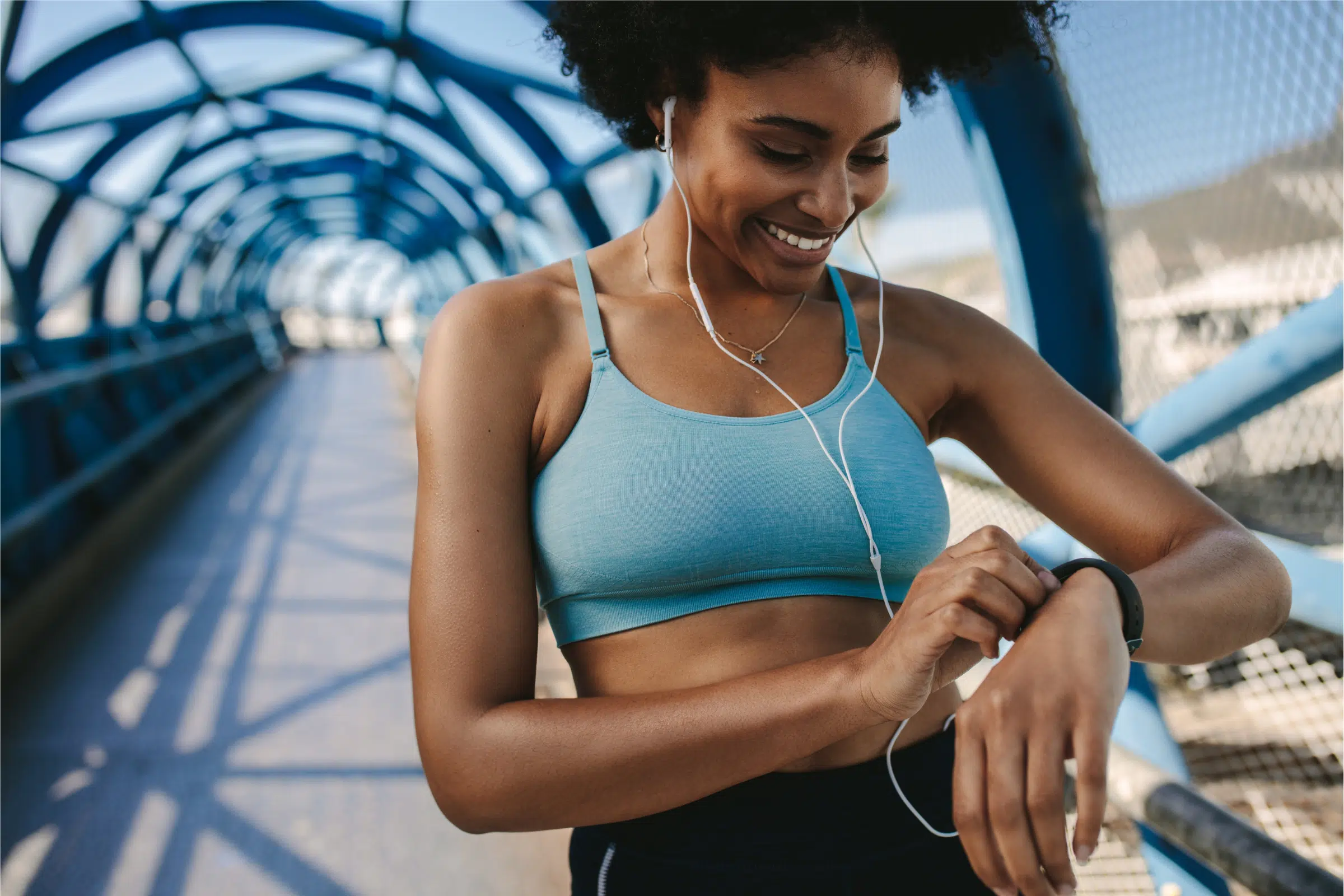 woman running with an apple watch and headphones