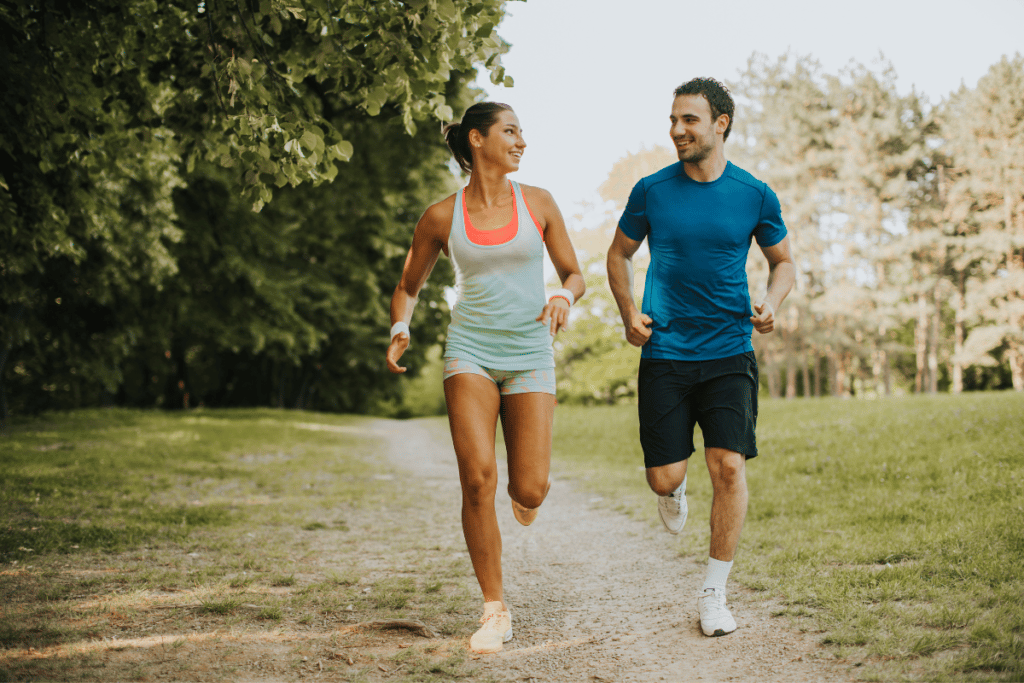 a couple running together in a park