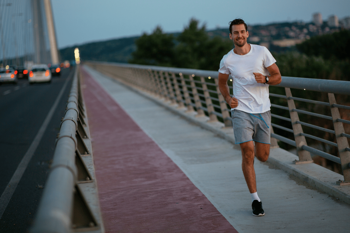 man running on a bridge