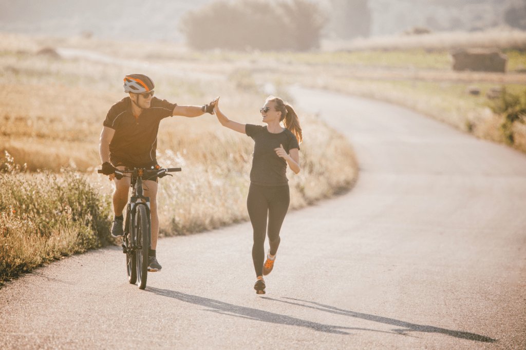 a couple running and biking together